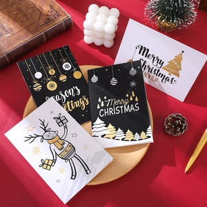 24-piece Christmas greeting card set with gold foil designs on festive red background