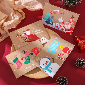 Close-up of four festive Christmas cards with envelopes on a red holiday backdrop