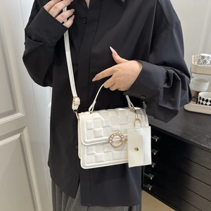 Elegant white woven chain shoulder bag with gold pearl buckle shown on female model