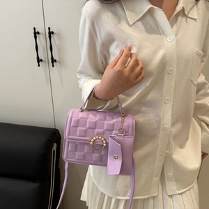 Lavender mini crossbody bag with quilted texture, pearl buckle, and detachable small pouch