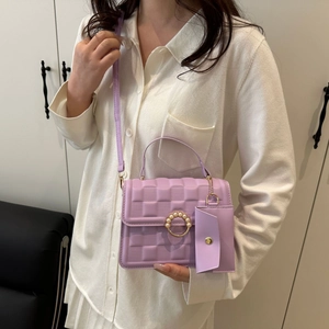 Close-up of purple checkered mini crossbody bag with pearl ring clasp and side pouch