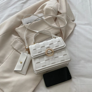 White quilted mini crossbody bag with gold ring closure and detachable coin purse