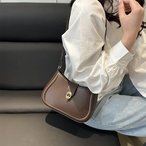 Retro brown leather underarm bag with gold oval buckle and slim shoulder strap