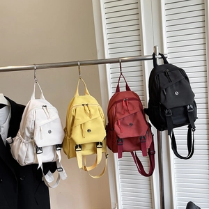 Minimalist large capacity nylon backpack in white, yellow, red, and black colors