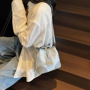 Fashionable light blue canvas bucket bag with floral texture and embroidery details