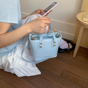 Chic light blue crossbody handbag with gold rivets and top handle for women