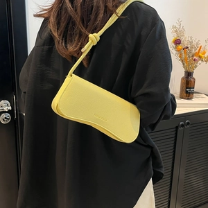 Chic lemon yellow pebbled leather shoulder bag with unique knotted strap for women