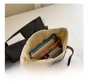 Top view of woven straw tote bag interior with leather handles and spacious compartment