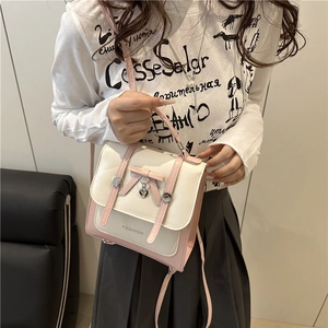 Pink and white color-block crossbody bag with bow decoration and heart pendant