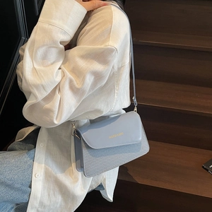 Light blue square crossbody bag with woven texture and gold hardware for women