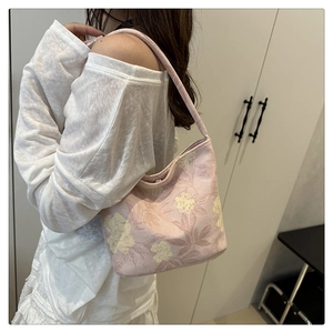 Floral print shoulder bag shown on model for daily style and capacity reference