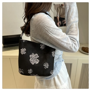 Detail of floral printed canvas shoulder bag with elegant white peony patterns