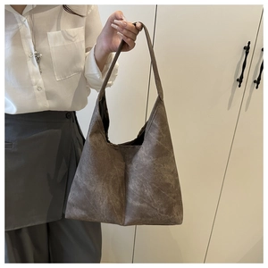 Detail of vintage tote bag with washed texture and spacious interior for daily use