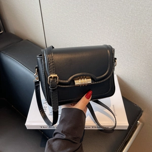 Classic black leather crossbody bag with gold buckle and adjustable strap for women