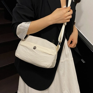 Cream multilayer nylon crossbody bag with textured fabric and adjustable strap