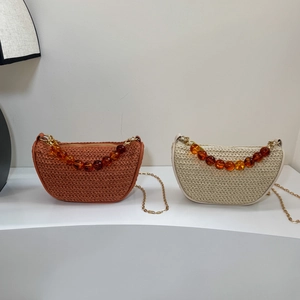 Chic crescent woven handbag with amber beaded handle and metal chain shoulder strap