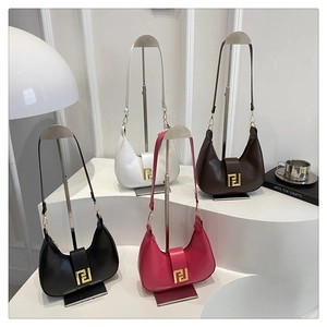 Detailed display of crescent shoulder bags in four colors on a minimalist display stand