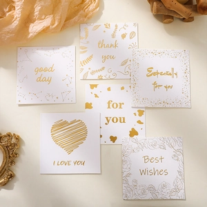 Macro detail of 6 square greeting cards with elegant gold foil stamping and envelopes