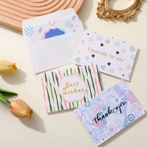 Floral and heart greeting card set with gold lettering and envelopes on a rustic table
