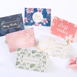Detail of assorted watercolor greeting cards with gold foil stamping and matching envelopes