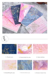 Detail view of six elegant gold foil greeting cards with floral motifs and envelopes