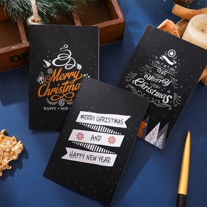 Detailed view of elegant black Christmas and New Year folding greeting cards with pine decor