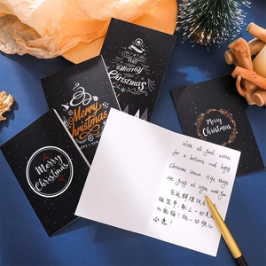 Foldable black Christmas greeting card with gold Merry Christmas text and a gold pen