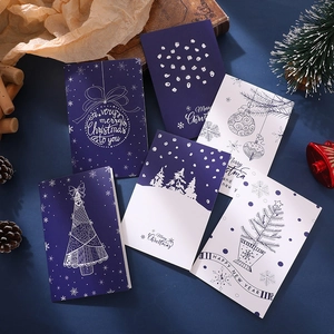 Detail of vintage Christmas cards with gold Merry Christmas lettering and festive props