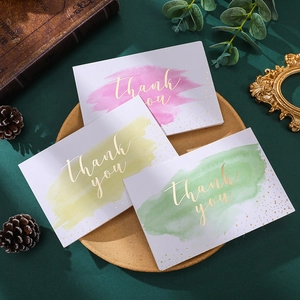 Watercolor thank you cards with gold foil lettering in three colors and envelopes