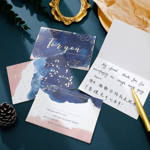 Macro view of gold foil stamped greeting cards with high-quality artistic paper textures
