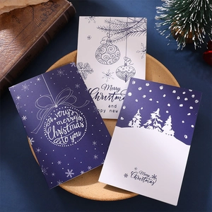 Set of vintage Christmas cards with envelopes, featuring snowflakes and pine tree patterns