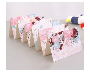 Detail of multi-fold floral thank you card with watercolor design and gold foil text