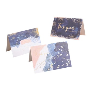 Three premium greeting cards with gold foil designs, watercolor art, and envelopes