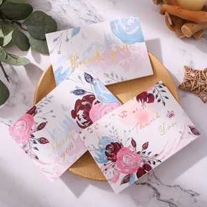 Floral Thank You greeting cards with gold foil lettering on a ceramic tray with greenery