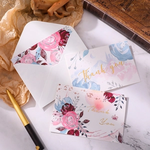 Floral Thank You cards with gold foil lettering and matching envelopes on marble background