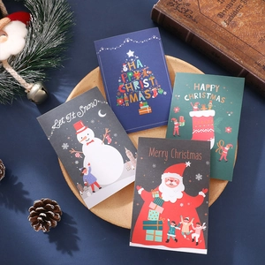 Close-up of assorted Merry Christmas cards with festive motifs on a rustic wooden tray