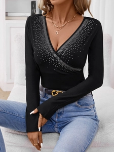Women's black V-neck long sleeve top with sparkling rhinestones and wrap design