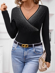 Women's black V-neck long sleeve top featuring sparkling rhinestones and slim fit design