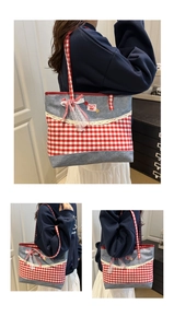 Detail of red and blue checkered denim tote bag featuring lace trim and a cherry patch