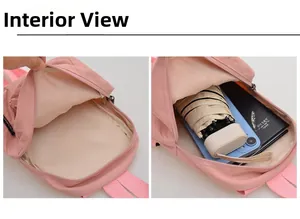 Internal compartment of pink nylon backpack showing capacity for umbrella and phone