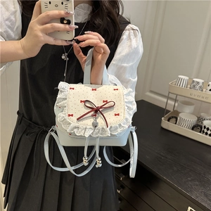 Lolita style blue lace bow backpack with ruffle edges and heart charm details