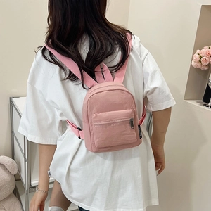 Mini pink nylon backpack for women with front zipper pocket and adjustable straps