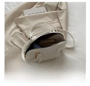Detailed view of the white quilted shell bag showing spacious interior for essentials