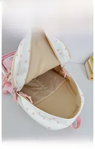 Detail view of pink star pattern backpack interior showing large main pocket and lining