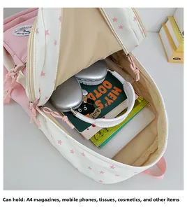 Spacious pink star pattern backpack showing internal storage for laptop and books