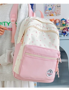 Pink and white student backpack with star prints shown in a campus life setting