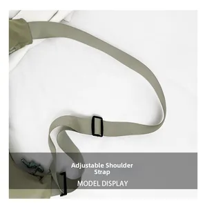 Detail of adjustable nylon shoulder strap on olive green crossbody dumpling bag