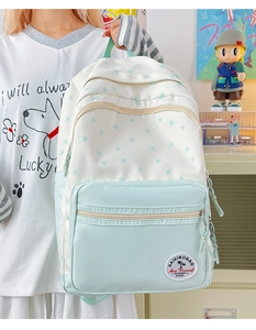 Detailed side view of large capacity blue star print backpack on a student model