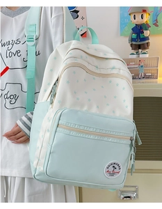 Close-up of the large capacity backpack with mint green panels and blue star patterns