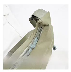 Detail of green nylon shoulder bag featuring smooth zipper and woven cord puller